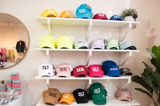 a wall of hats on shelves in a store