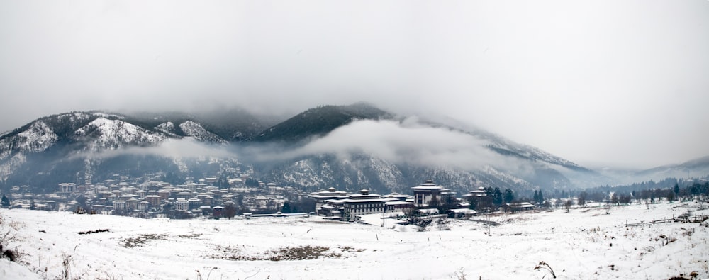 a snow covered mountain with a town in the distance