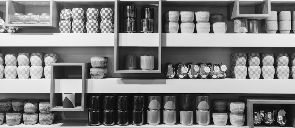 a shelf filled with lots of different types of cups