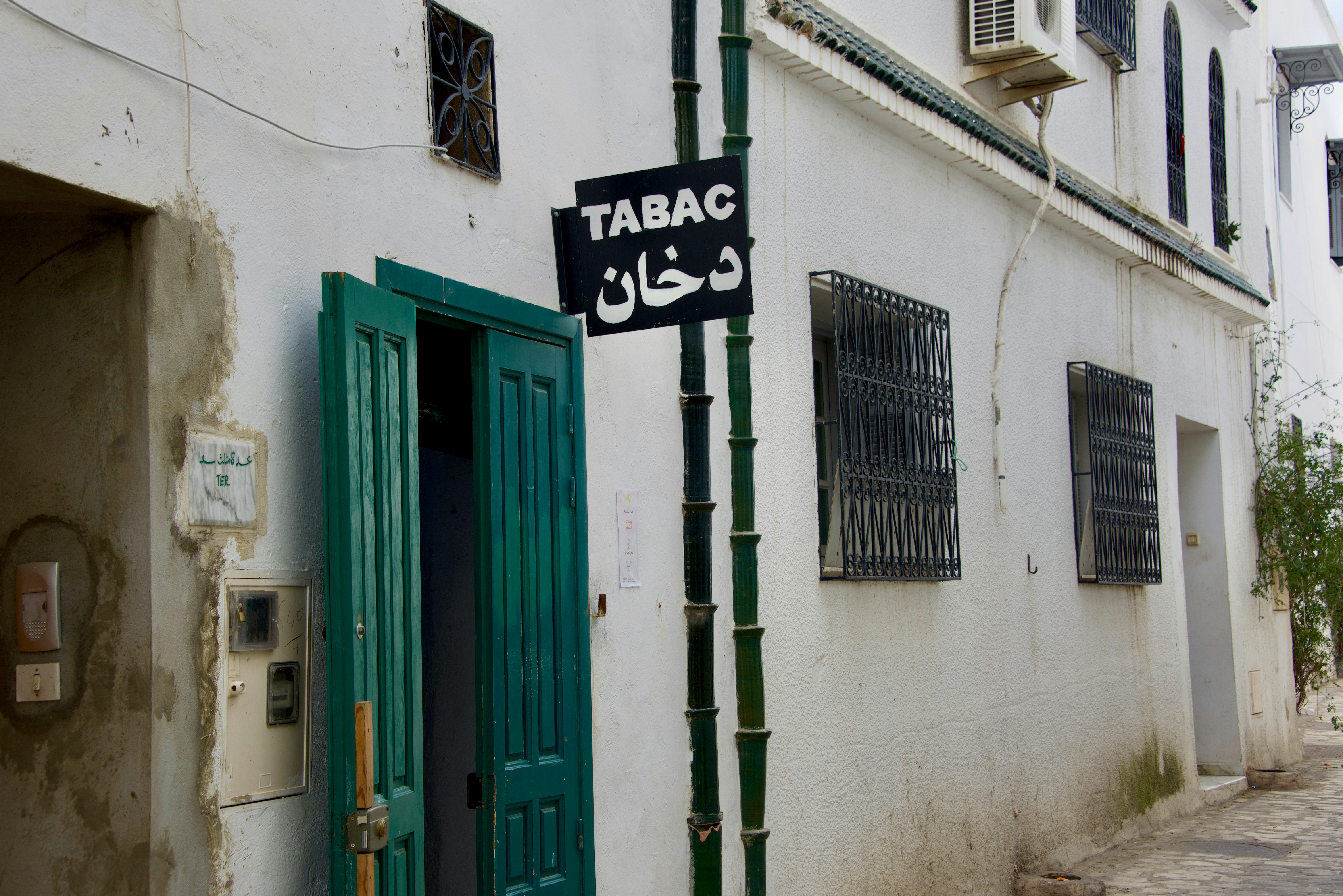 a street sign on a pole in front of a building