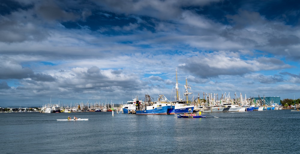 a harbor filled with lots of boats under a cloudy sky