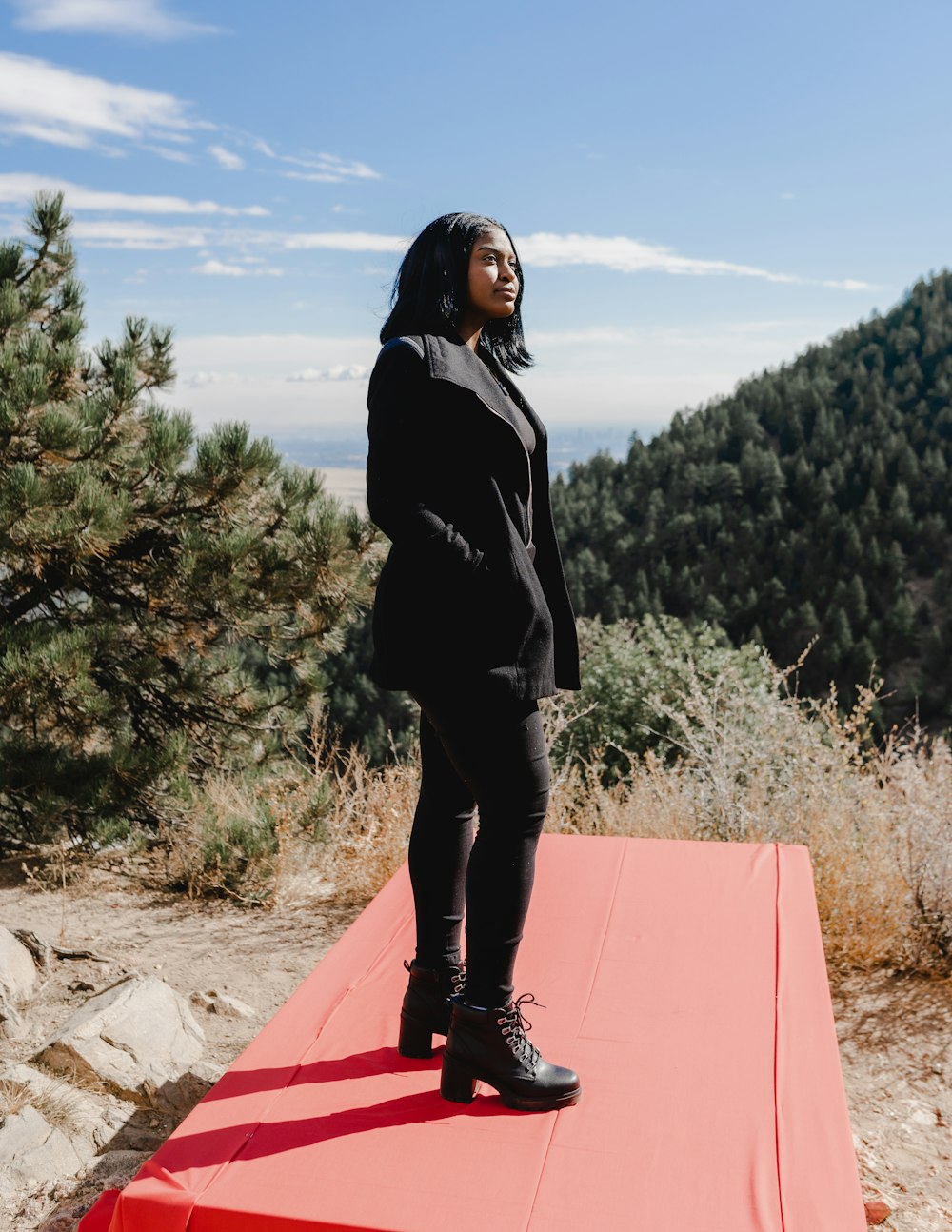 a woman standing on top of a red platform