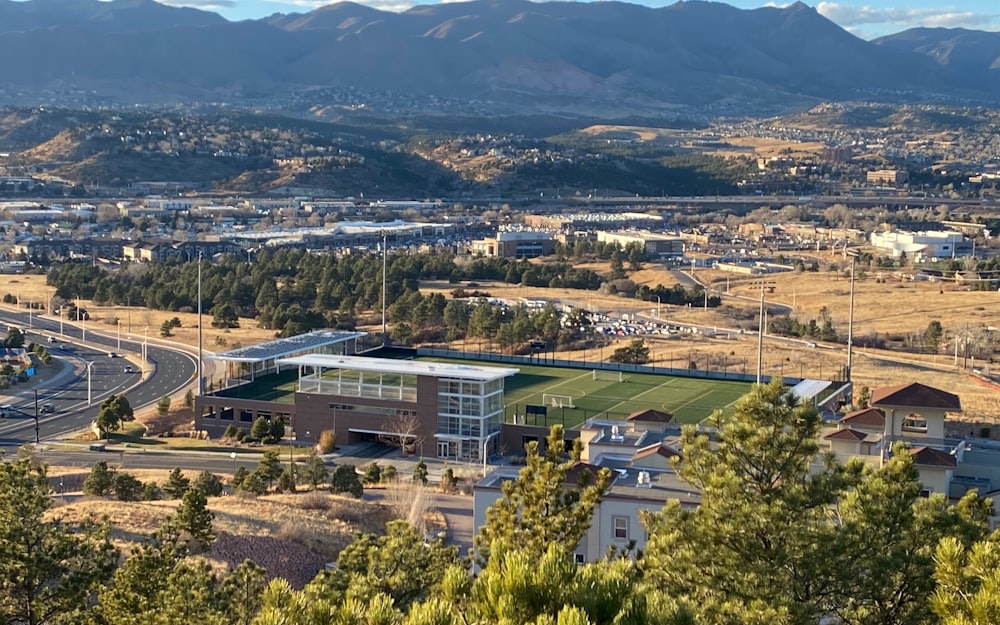 an aerial view of a city with mountains in the background