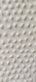 a black and white photo of a white wall