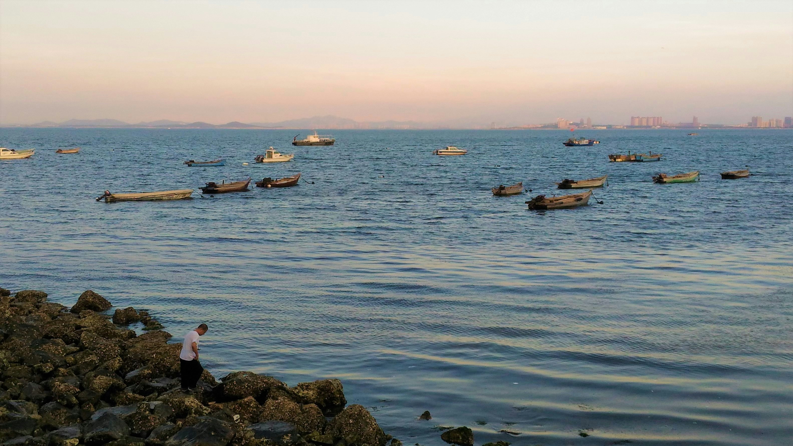 a group of boats floating on top of a large body of water