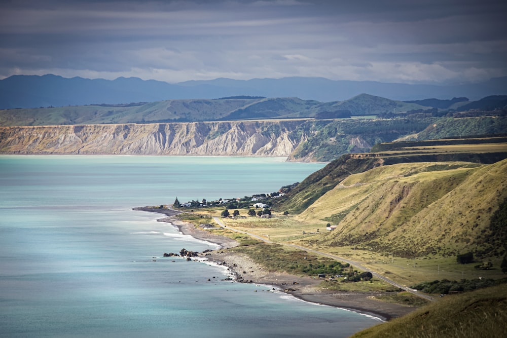 a body of water with mountains in the background