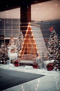 a display of christmas trees and a bench