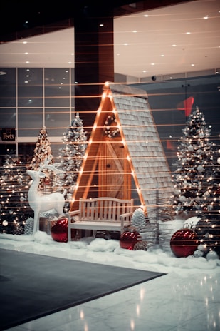 a display of christmas trees and a bench
