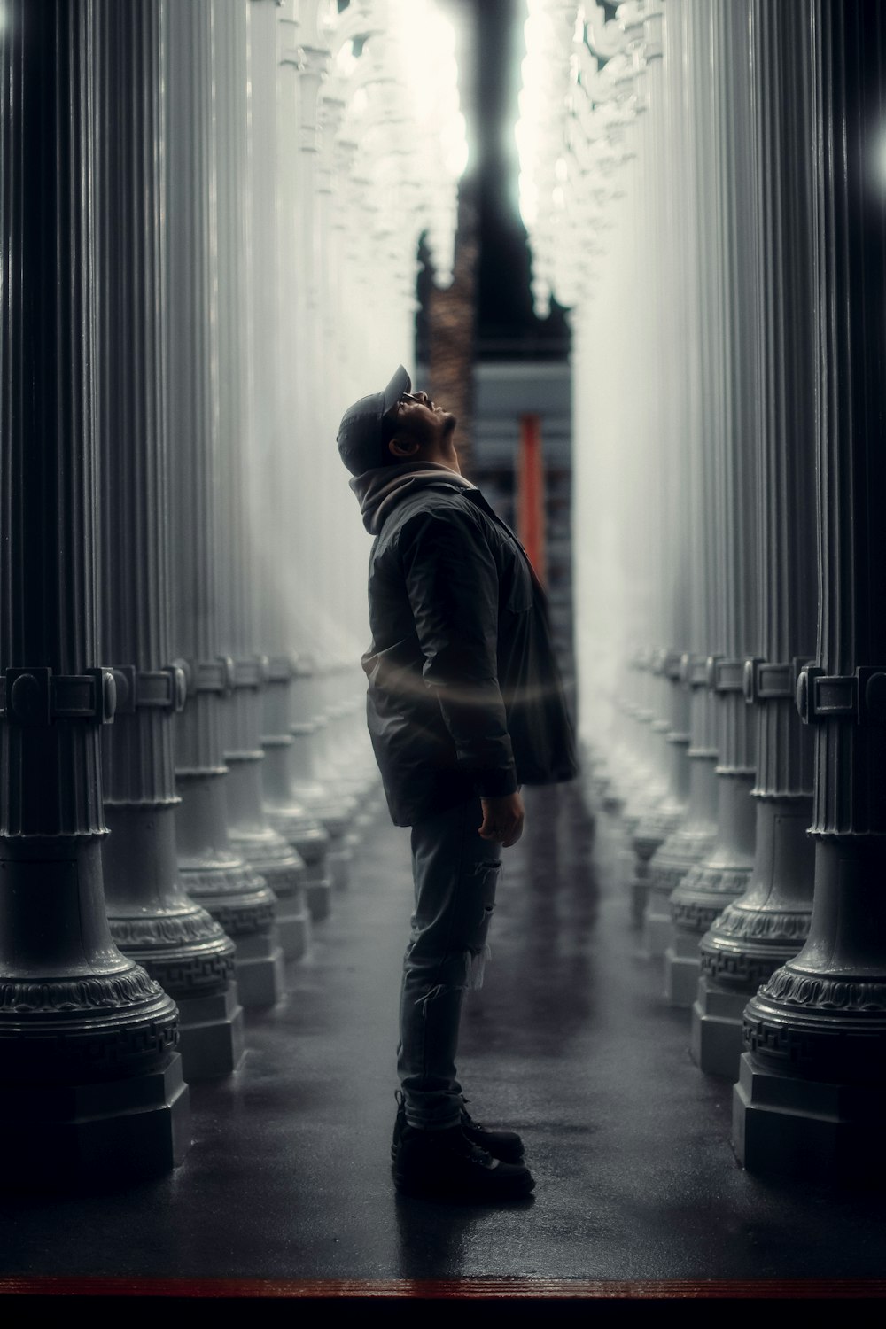 a man standing in the middle of a hallway