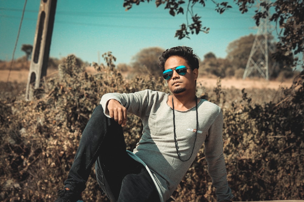 a man sitting on top of a wooden bench