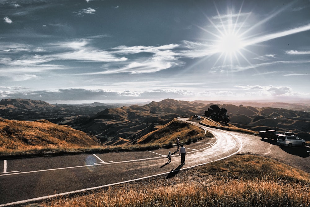 a couple of people standing on the side of a road