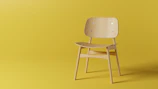 Bright minimalistic wooden chair with clean lines in a sunlit gallery space.