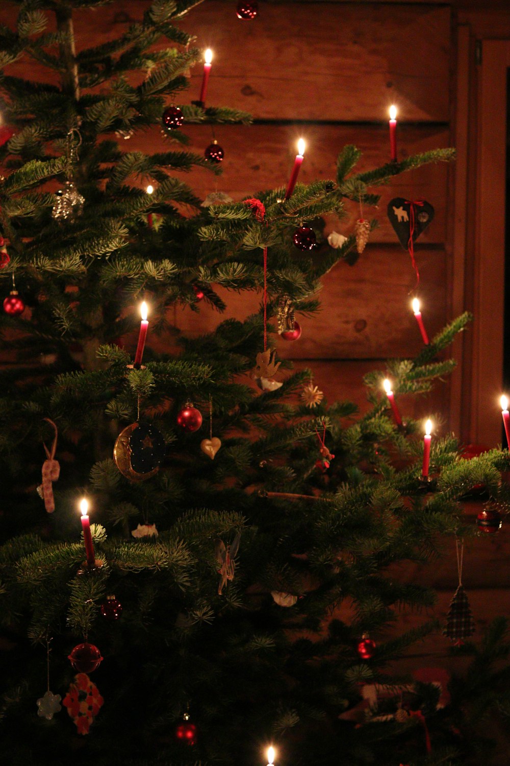 a christmas tree with a lit candle in it