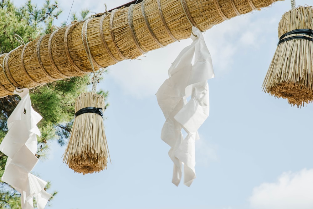 a close up of a bunch of straw hanging from a pole