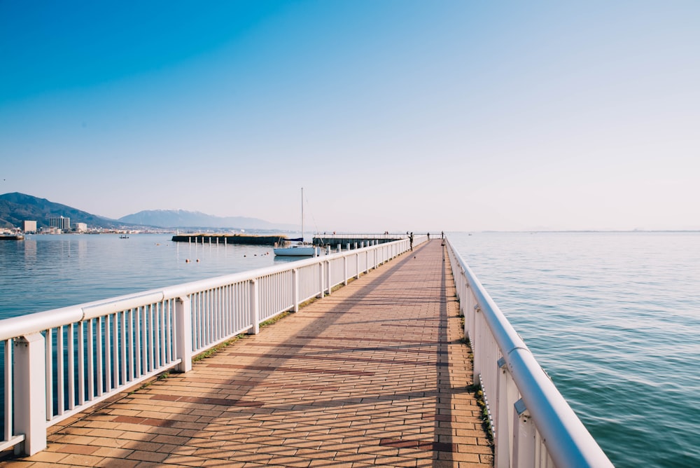 a long pier stretches out into the water