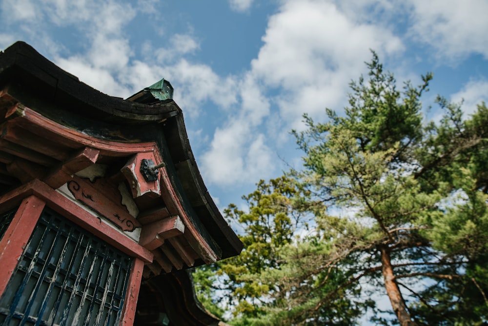 a tall wooden building sitting next to a forest