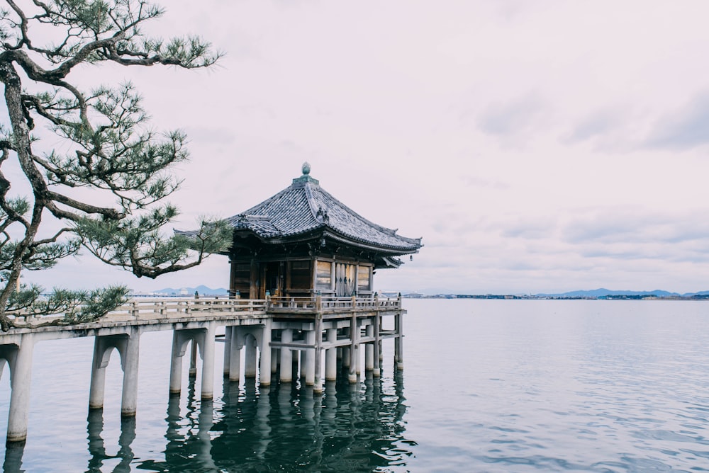 a wooden pier with a building on top of it