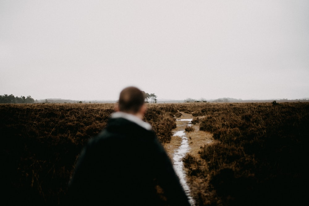 a man standing in the middle of a field