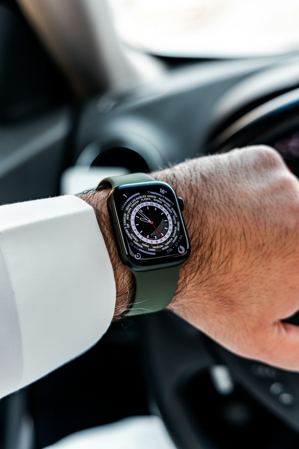 a man is holding the steering wheel of a car