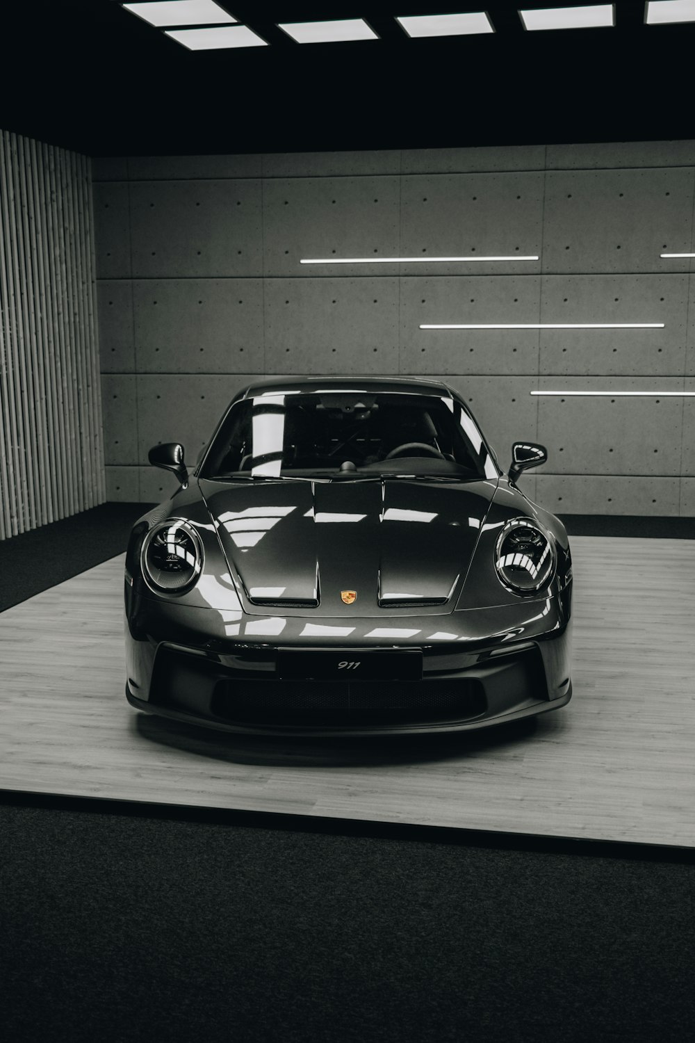 a black and white photo of a car in a garage