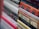 A stack of books with various titles is shown, featuring religious and spiritual themes. The spines are vertically aligned, showcasing different fonts and colors. Some titles include words like 'God' and 'Devotional,' suggesting content related to theology or religious studies. The image is focused on the books in the foreground, with the background slightly blurred.