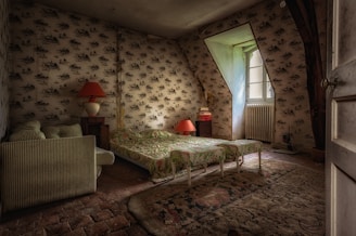 a bedroom with a bed and a chair in it