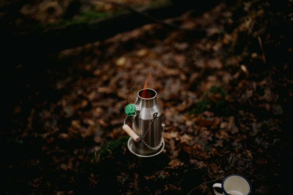 a cup of coffee sitting on top of a metal cup holder