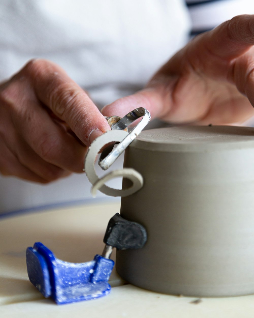 a person working on a sculpture with a pair of scissors