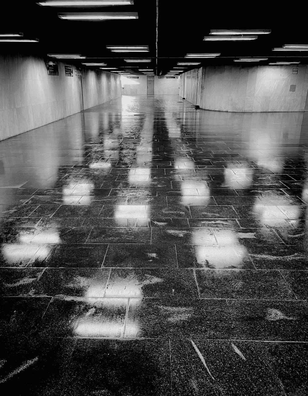 a black and white photo of an empty parking garage