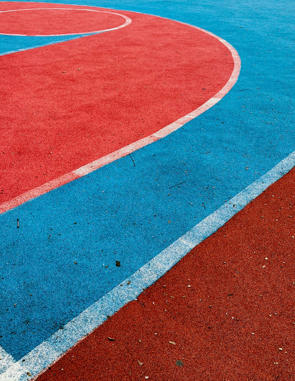 a red and blue basketball court with a white line