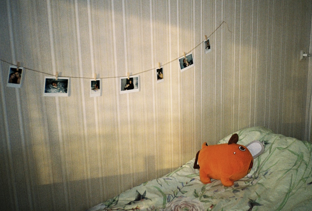 a stuffed animal is laying on a bed