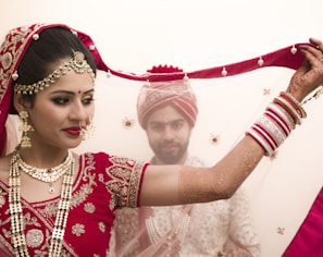 a woman in a red and white bridal outfit