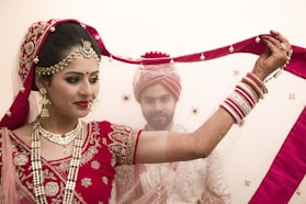 a woman in a red and white bridal outfit