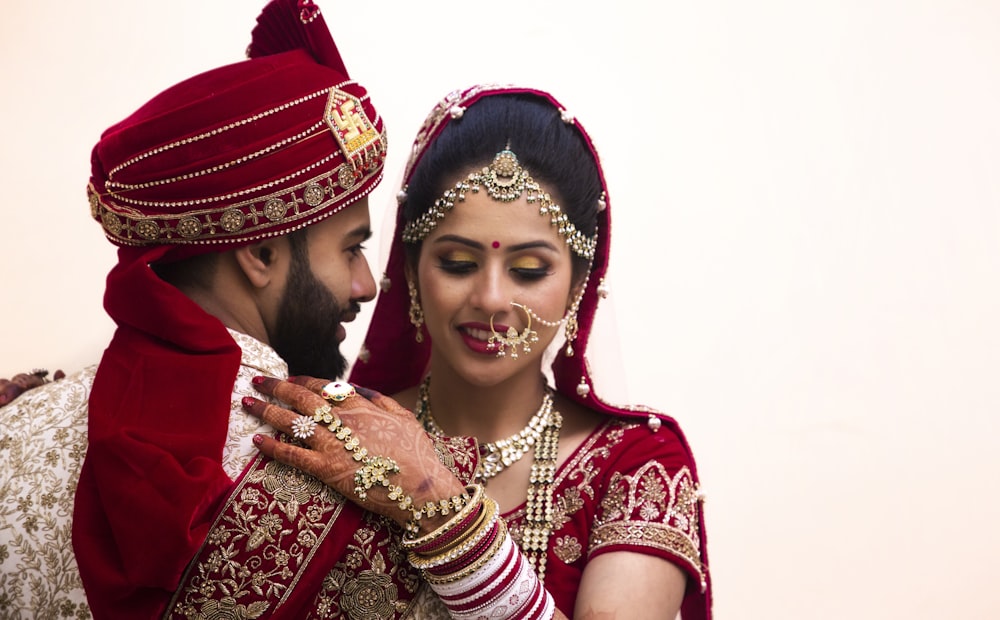 a man and woman dressed in traditional indian garb