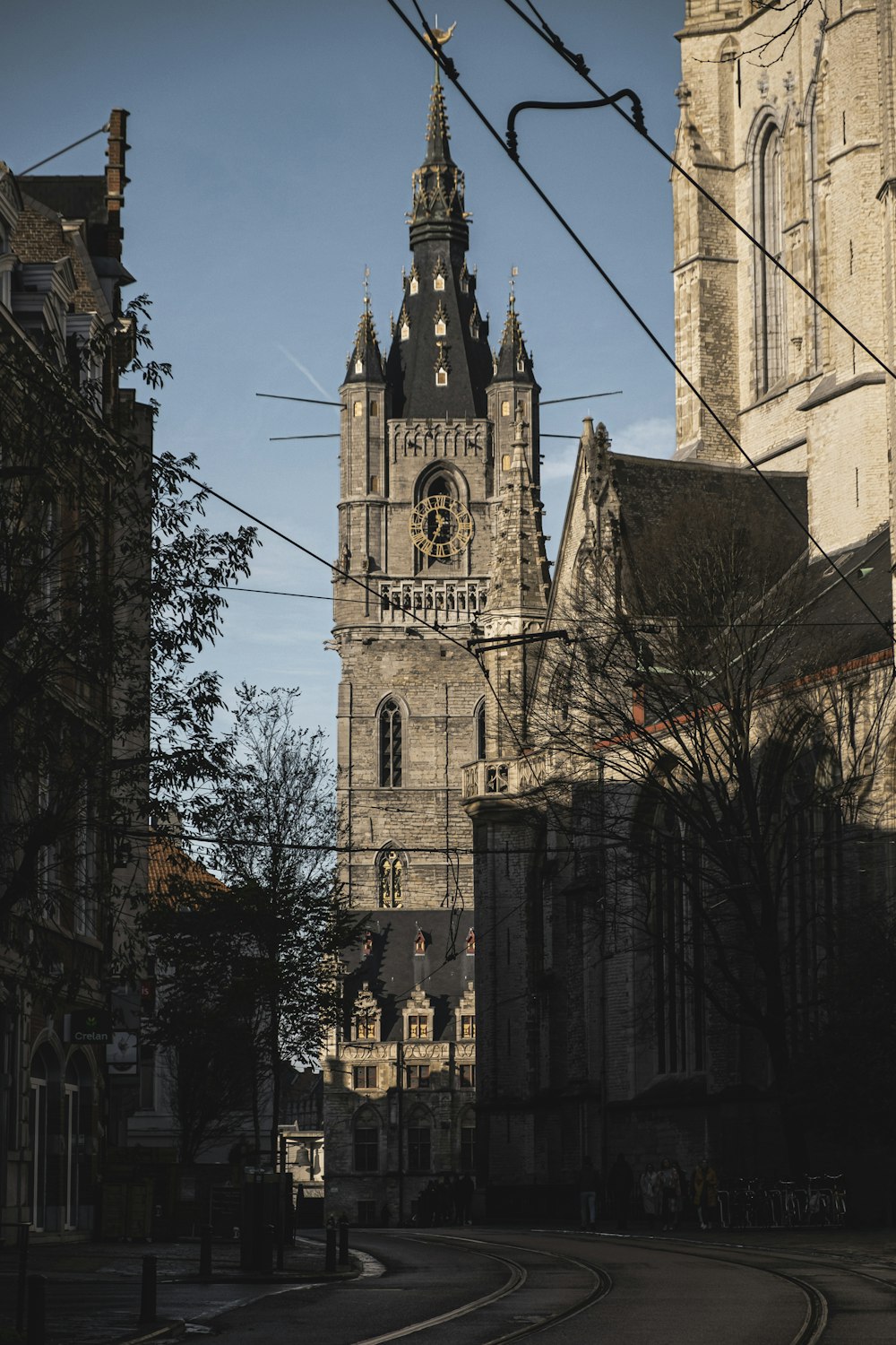 a church tower with a clock on the side of it