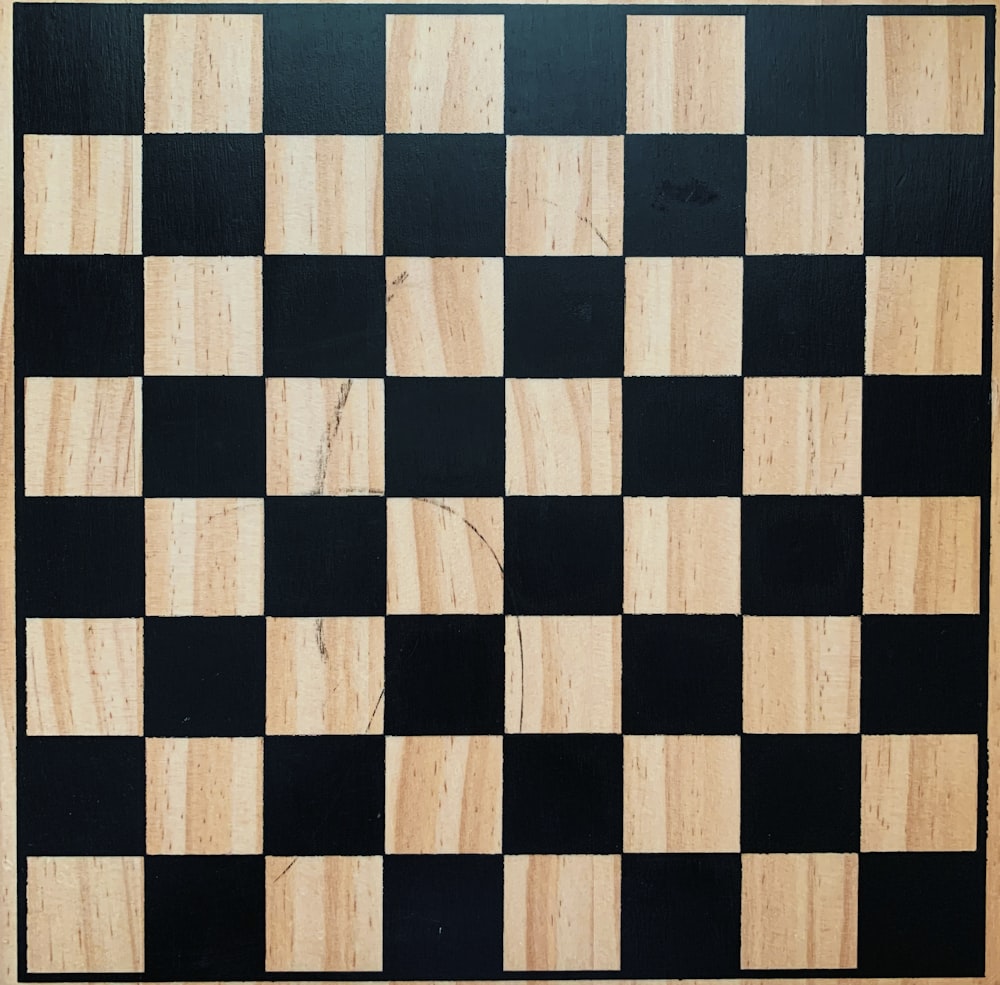 a black and white checkered board with a wooden frame