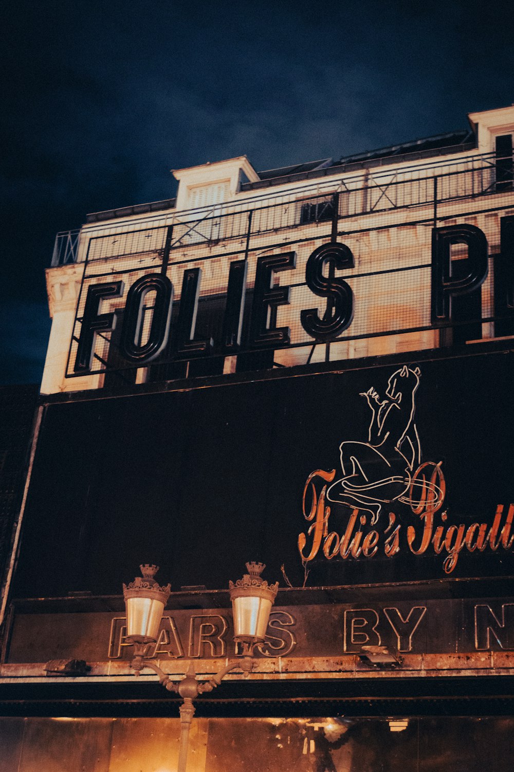 a sign on the side of a building that says folies piu '