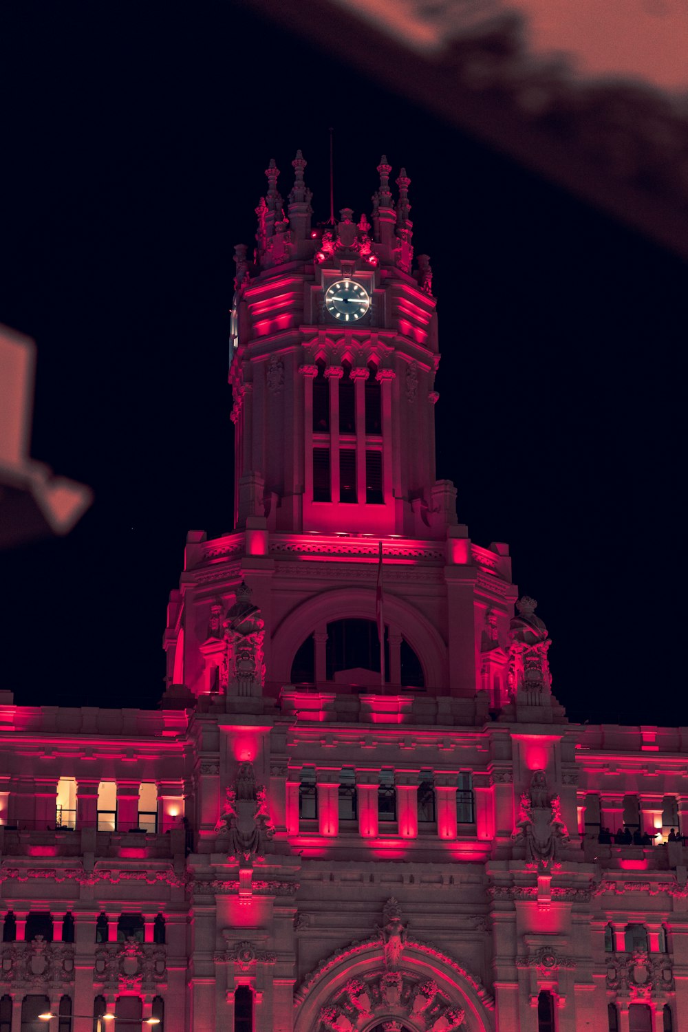 a large building with a clock tower lit up at night