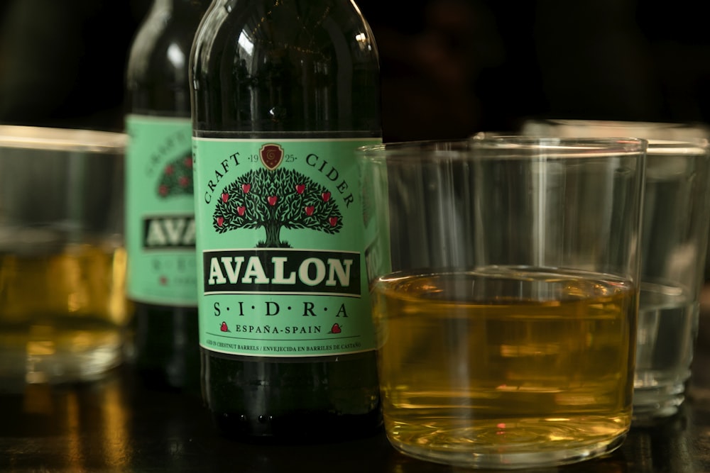 a close up of a bottle of alcohol next to glasses