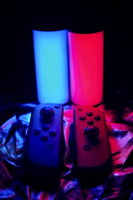 three video game controllers sitting next to each other