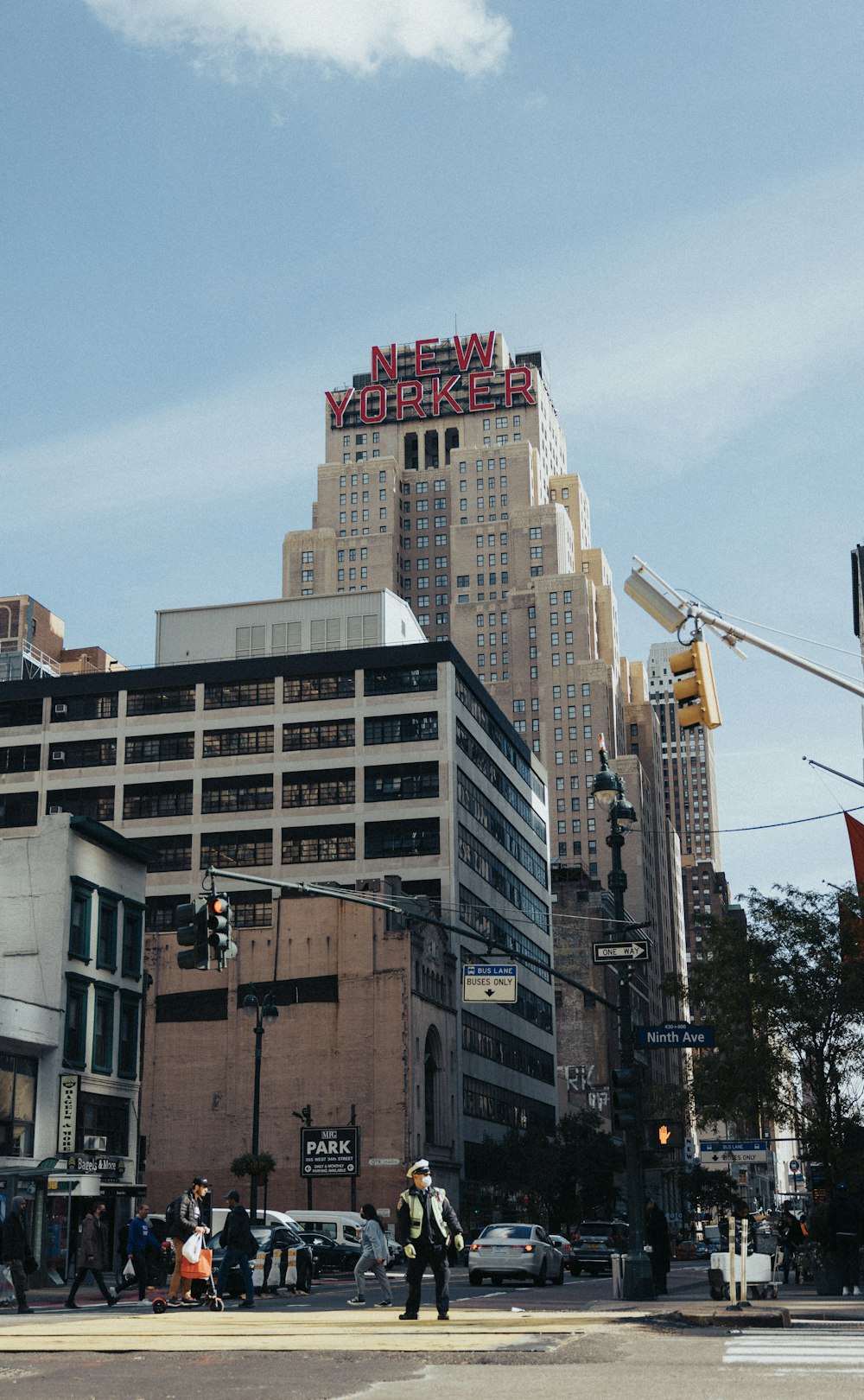 a man standing on a street corner in front of a tall building