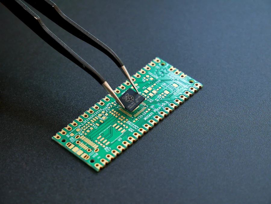 Tweezers placing a microchip onto a circuit board