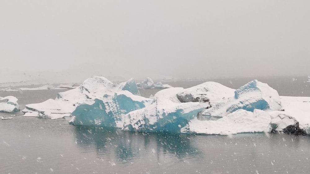 a group of icebergs floating on top of a body of water