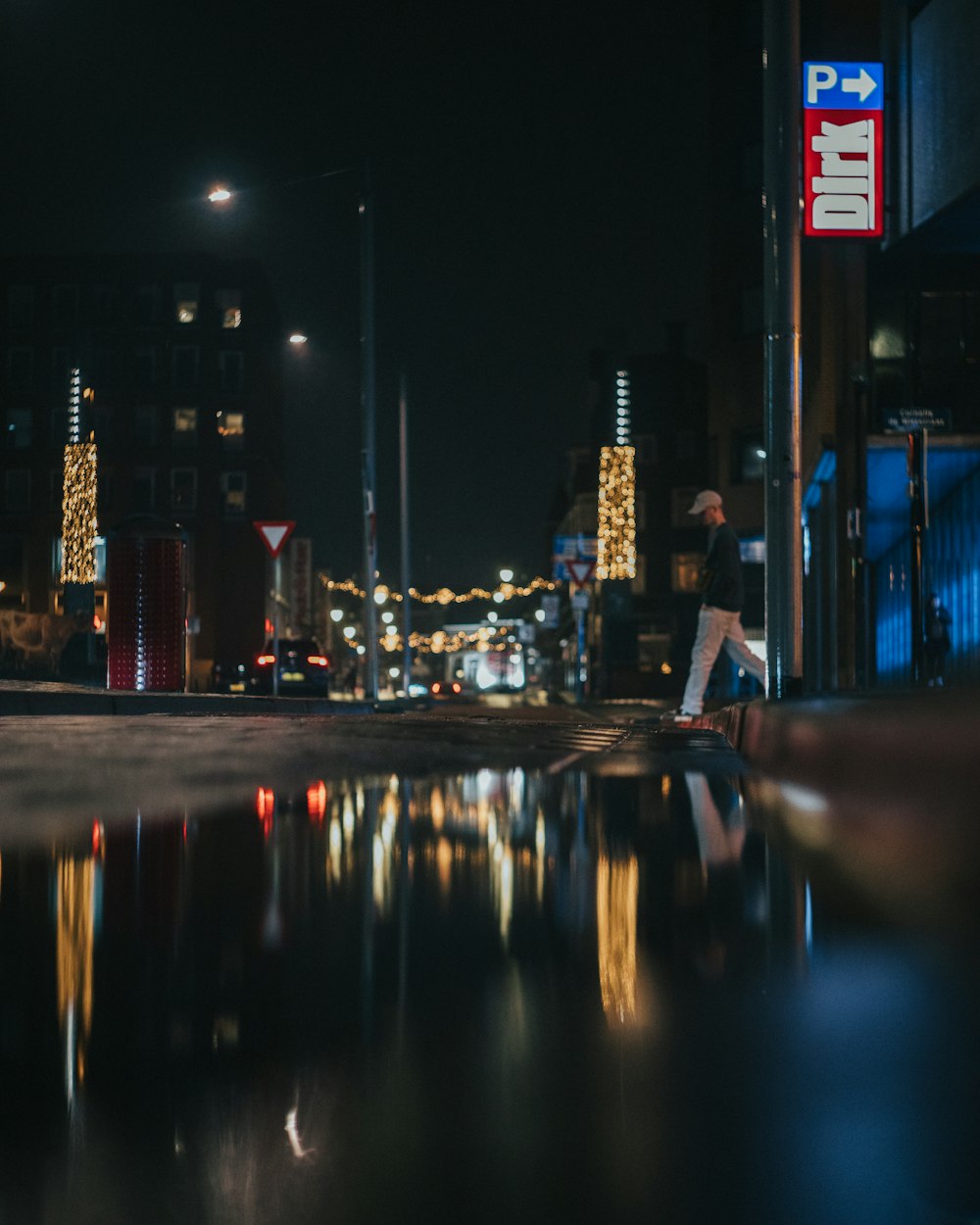 a person riding a skateboard on a city street at night