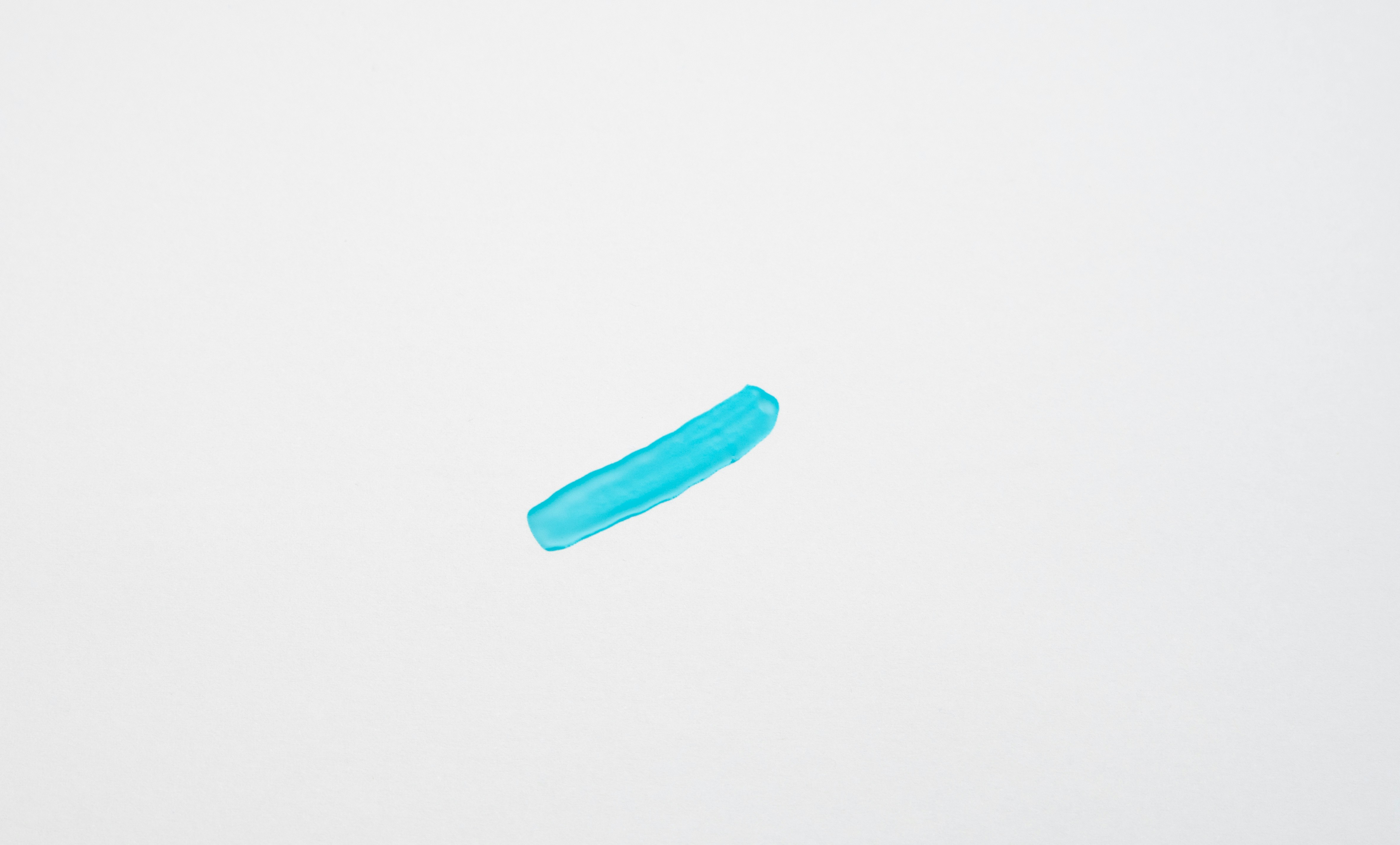 a blue object floating in the air on a white background