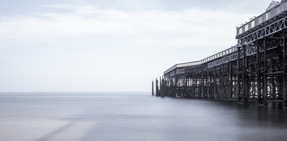 a long exposure of a pier on a foggy day