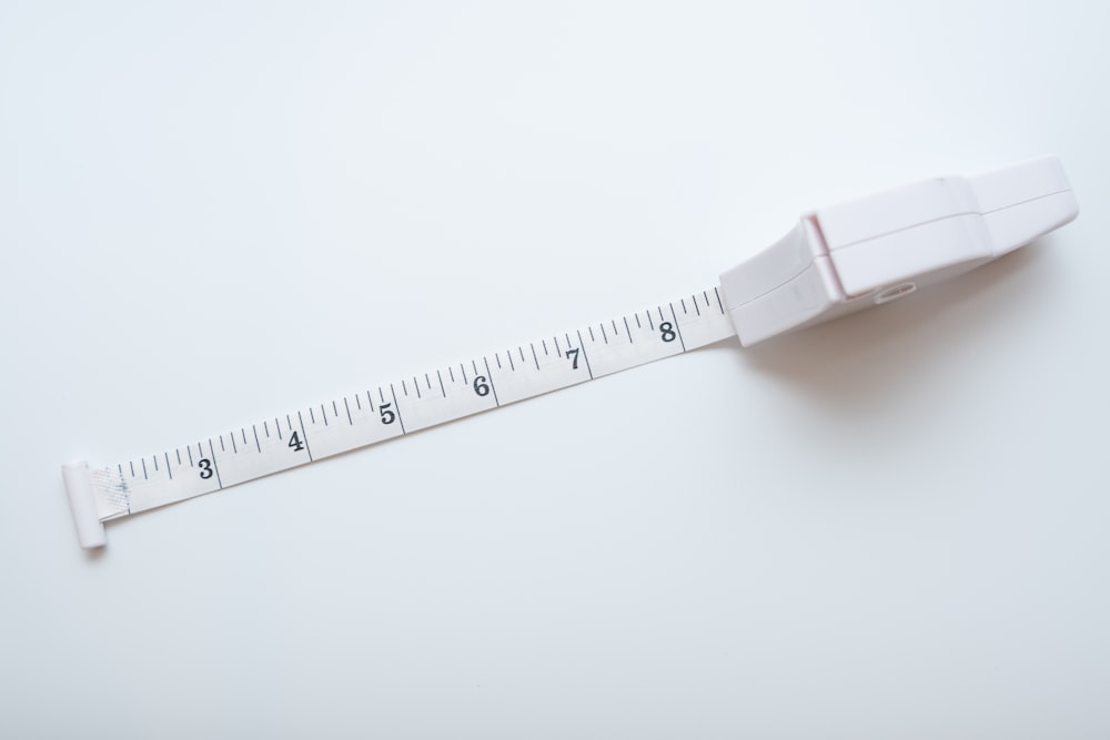 a white measuring tape with a white background