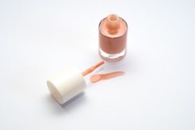 a bottle of liquid sitting next to a tube of liquid