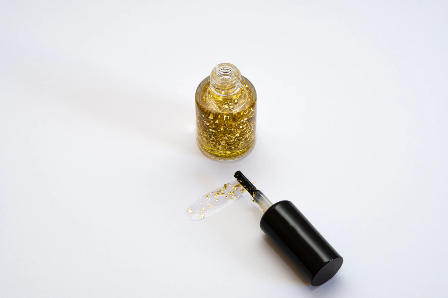 Starfield Glitter Topcoat, an open bottle of gold-flake polish with its brush beside it — only four left