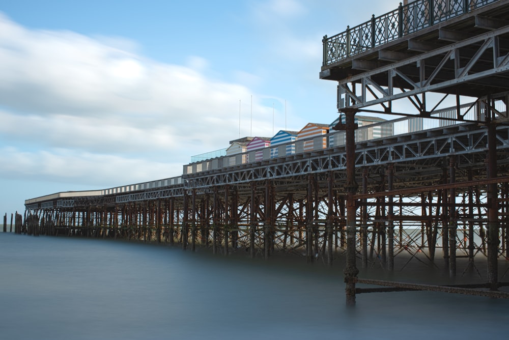 a train on a train track next to a pier